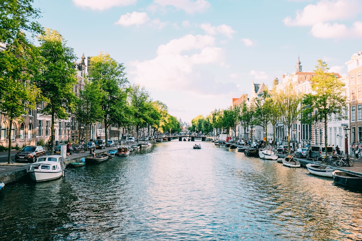 Amsterdam skyline at sunset — departure city for flights to Rome