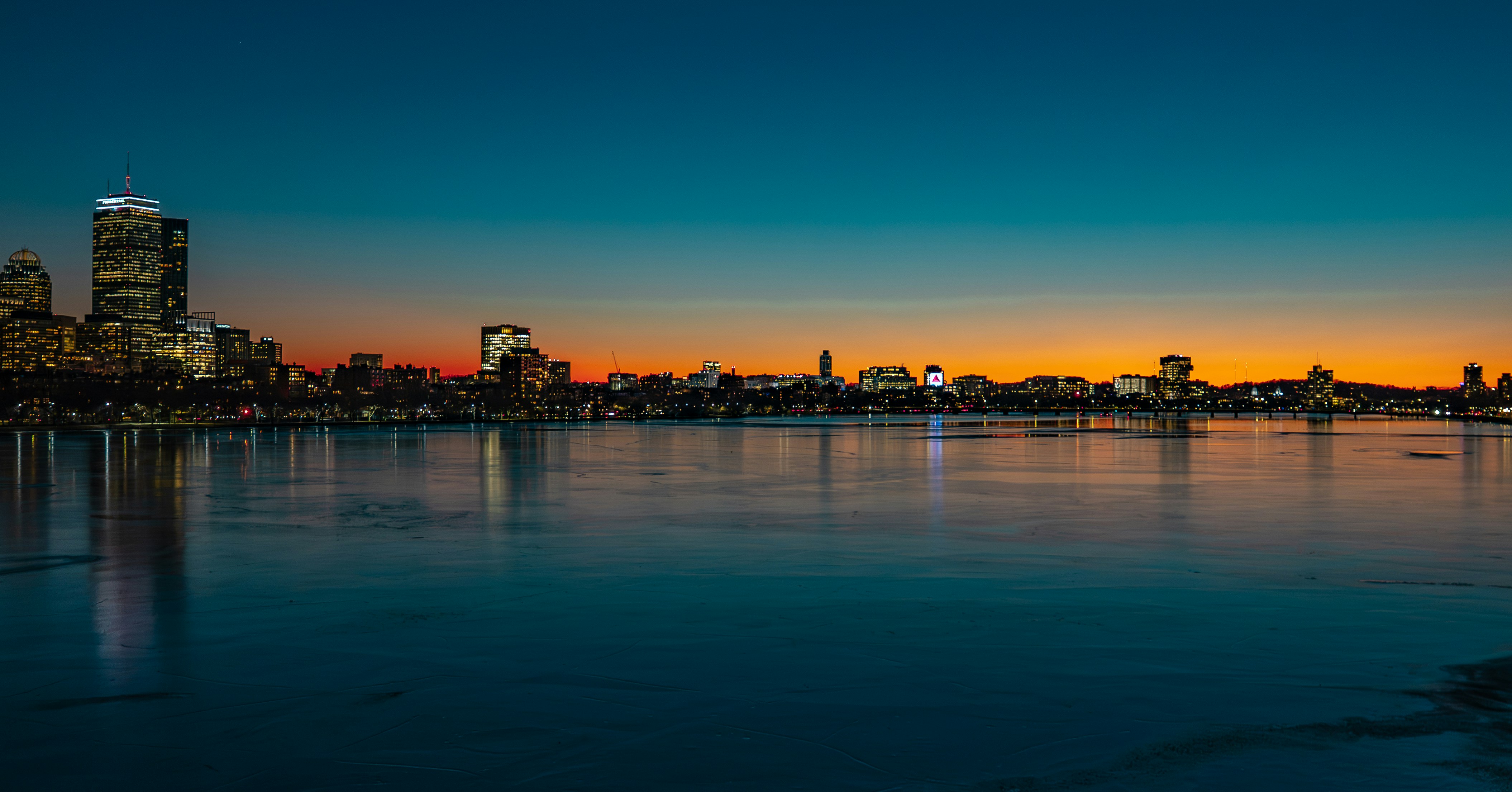Boston skyline at sunset — departure city for flights to Miami